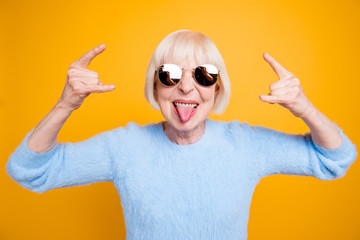 Close up portrait of  modern granny hold hands up and showing si