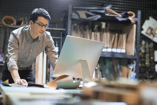 Young man using computer in studio