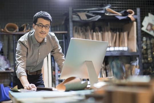 Young man using computer in studio
