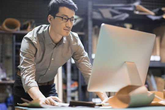 Young man using computer in studio