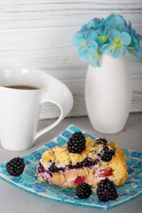A piece of homemade baking berry pie lies on a mosaic glass plate.