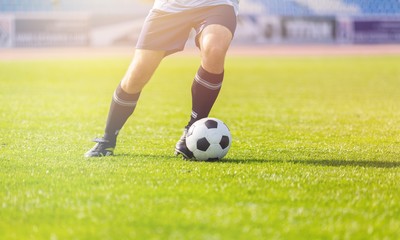 Running soccer player on grass