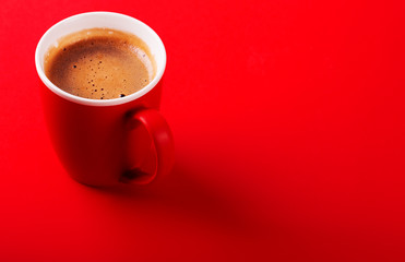 A cup of fragrant coffee on a red background for your design. Advertising coffee.