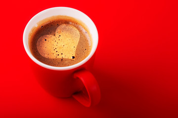 A cup of fragrant coffee on a red background for your design. Advertising coffee.