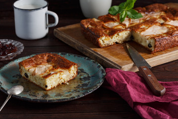 Homemade pear pie on rustic wooden table.