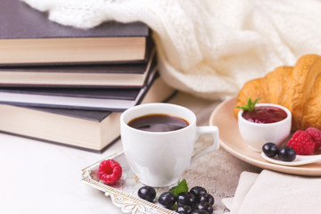 Coffee, croissant, plaid and books. Education concept. Selective focus