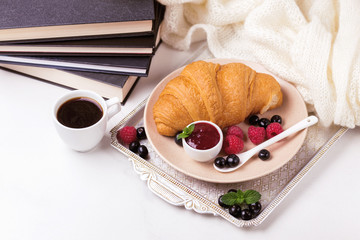 Coffee, croissant, plaid and books. Education concept. Selective focus