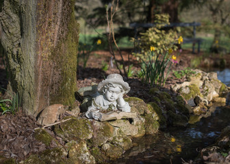 Statue of Child Reading Under Tree