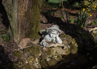 Statue of Child Reading Under Tree