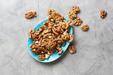 Walnut kernels on gray background.