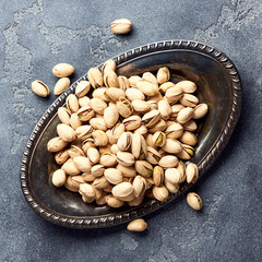 Pistachios on gray background. Top view of nuts.