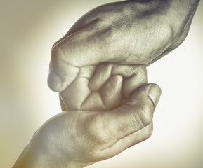 Male and female hands connect with each other. Black and white image.