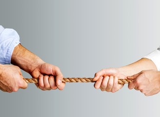 Tug war, two businessman pulling a rope