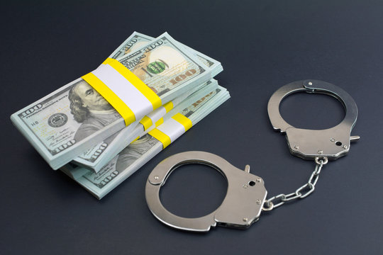 money and handcuffs. financial crime Card Fraud Fund Transfer Scams concept