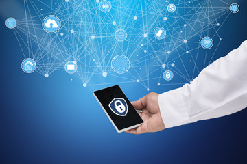 Business People hold a smartphone with an interface icon that deals with security, communication and multiple forms of online protection.