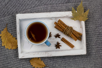 spicy warming tea on a wooden vintage tray top view