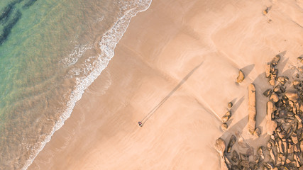 Aerial View of Waves and People and Beach Along Great Ocean Road, Victoria, Australia at Sunrise