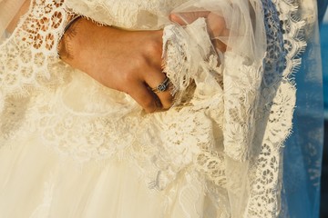 Bride preparing for her wedding, putting on the garter and lingerie