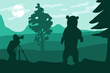 Fototapeta na wymiar Photographer photographs bear in nature.