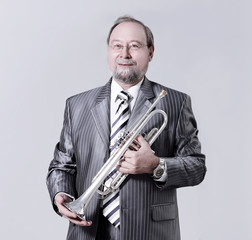 man in a gray suit with a trumpet
