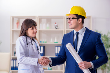 Doctor discussing new hospital plan with architect