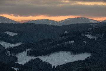Fototapeta na wymiar Winter landscape of a mountain range in winter. Sunset in the mountains.