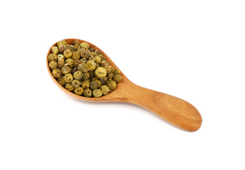 Wooden scoop spoon full of green peppercorns
