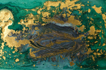 Green marble abstract acrylic background. Marbling artwork texture. Agate ripple pattern. Gold powder.