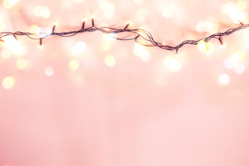 Yellow garland on a pink background. Holiday Christmas concept