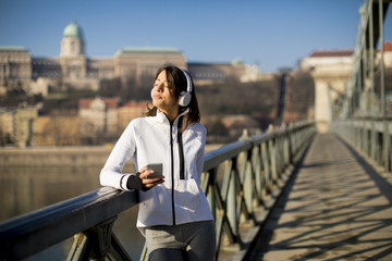 Young athlete woman with mobile phone outdoor