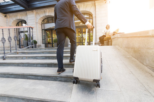 Man holding suitcase. businessman with luggage travels, goes to a business meeting