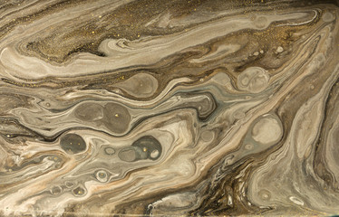 Gold marbling texture design. Beige and golden marble pattern. Fluid art.