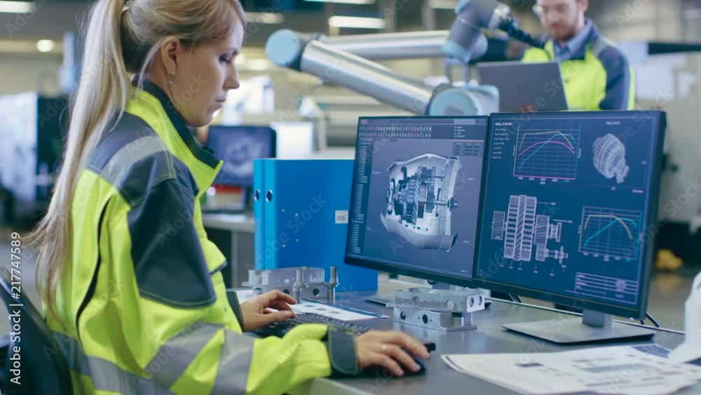 Poster at the factory: female mechanical engineer designs 3d engine on her personal computer, male automati