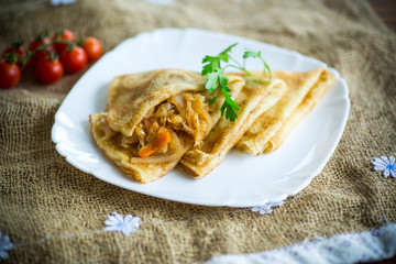 thin fried pancakes stuffed with stewed cabbage in a plate