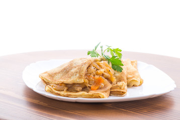 thin fried pancakes stuffed with stewed cabbage in a plate