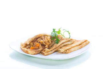thin fried pancakes stuffed with stewed cabbage in a plate