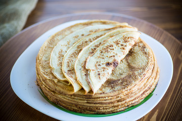 big high stack of thin pancakes in a plate