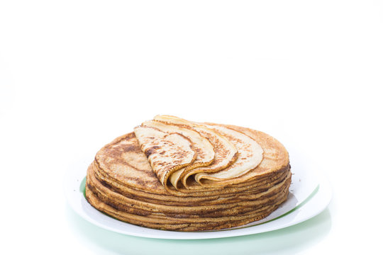 big high stack of thin pancakes in a plate