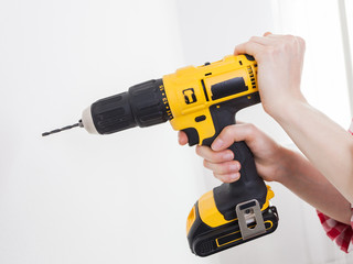 Hand holding yellow drill
