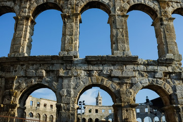 The detail of Arena Pula with cloudy sky in the background