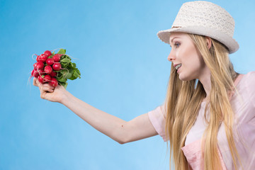 Young woman holding radish