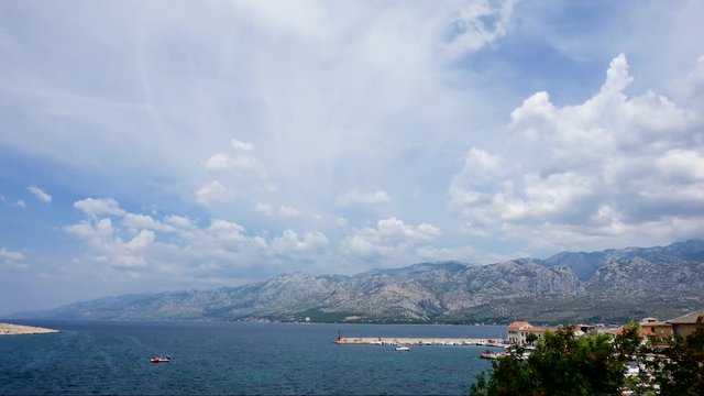 Timelapse on the sea of Vinjerac in Croatia with mountains in the background during a sunny day