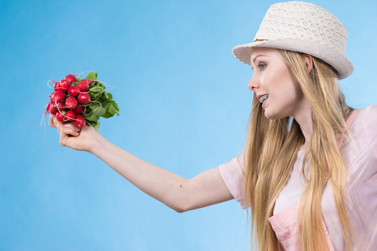 Young woman holding radish