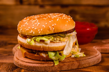 Hamburger and sauce on a wooden table