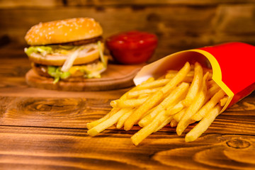 Hamburger and french fries on wooden table