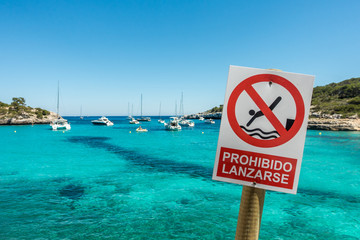Warning sign on the beach Cala Mondrago on the island of Mallorca