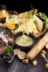 Gourmet Swiss fondue dinner on a winter evening with assorted cheese