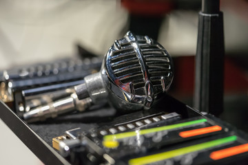 Vintage microphone with some harmonicas on the side