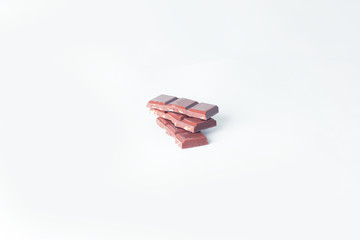 stack pieces of chocolate with nuts isolated on white