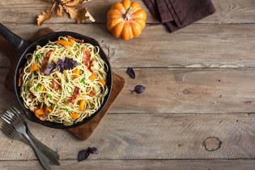 Fototapeta na wymiar Autumn pasta with pumpkin and bacon